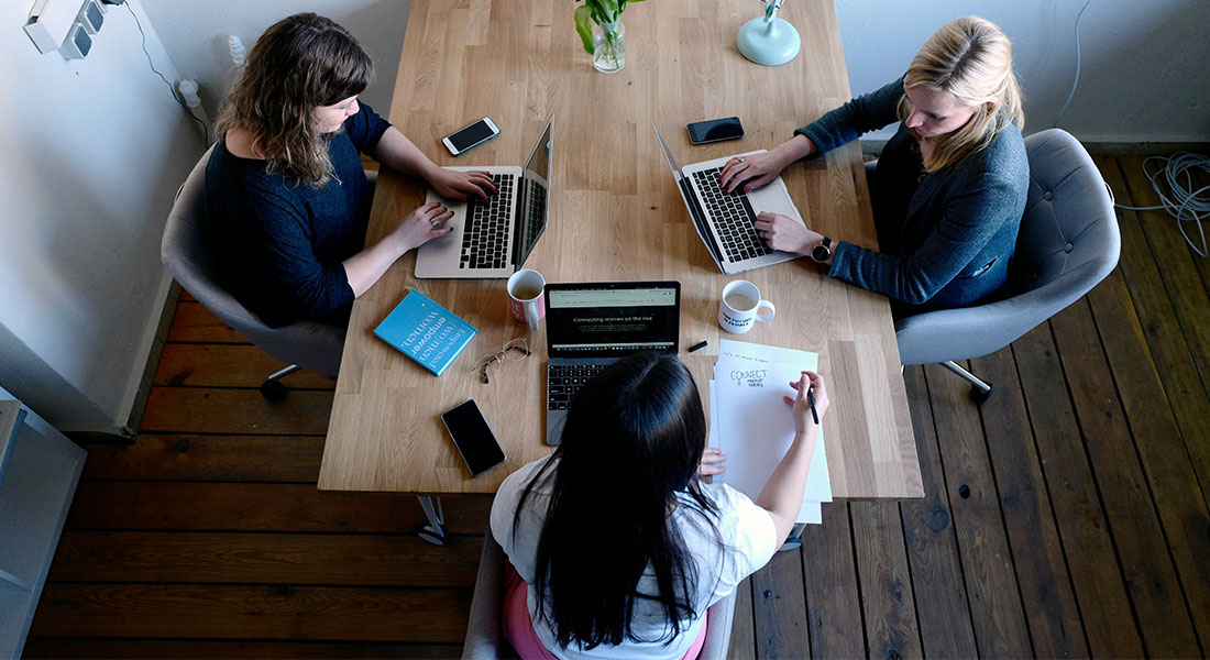 How to get a business loan - photo of three women working on laptops