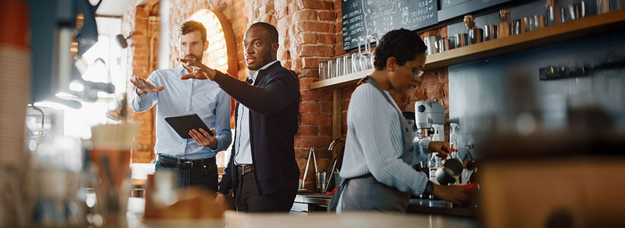 Coffee shop owner meeting with manager - Buy a Business Loan