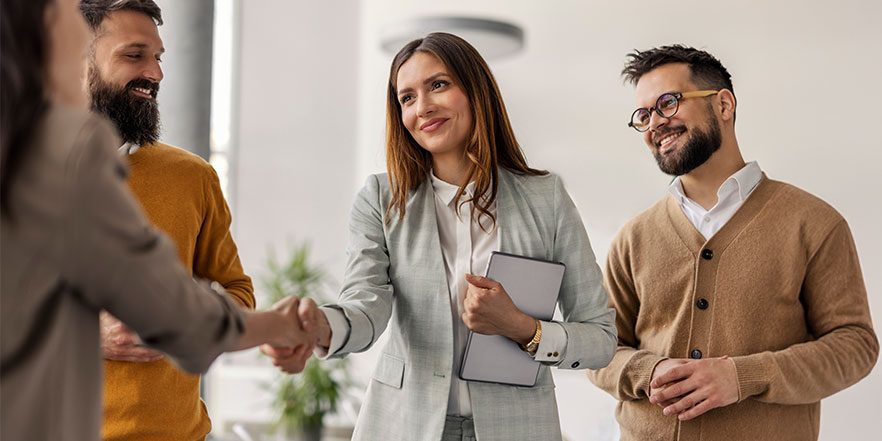Business people shaking hands - Buy a Business Loan