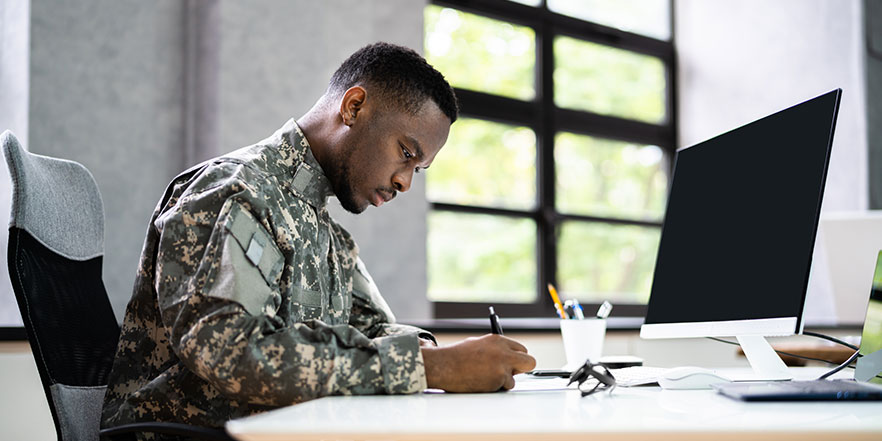 Veteran doing work at desk - Buy a Business Loan
